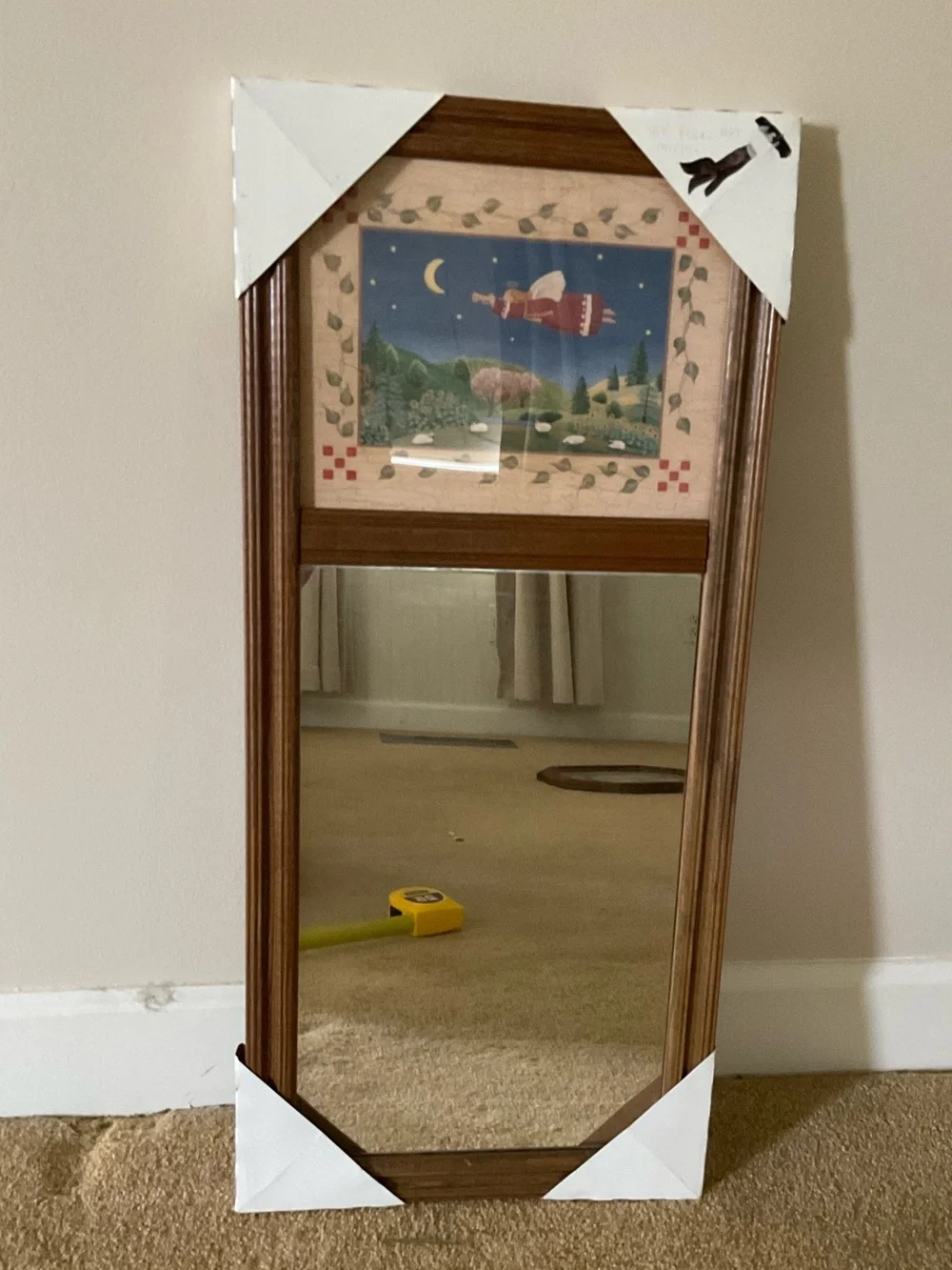 Vintage wood-framed trumeau mirror with a folk art print
